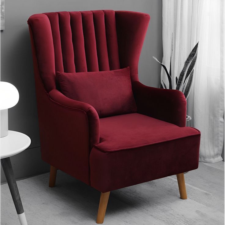 Burgundy velvet channel-back accent chair with wood legs