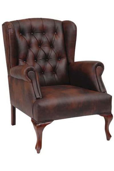 Antique brown leather tufted wingback chair with turned wood legs