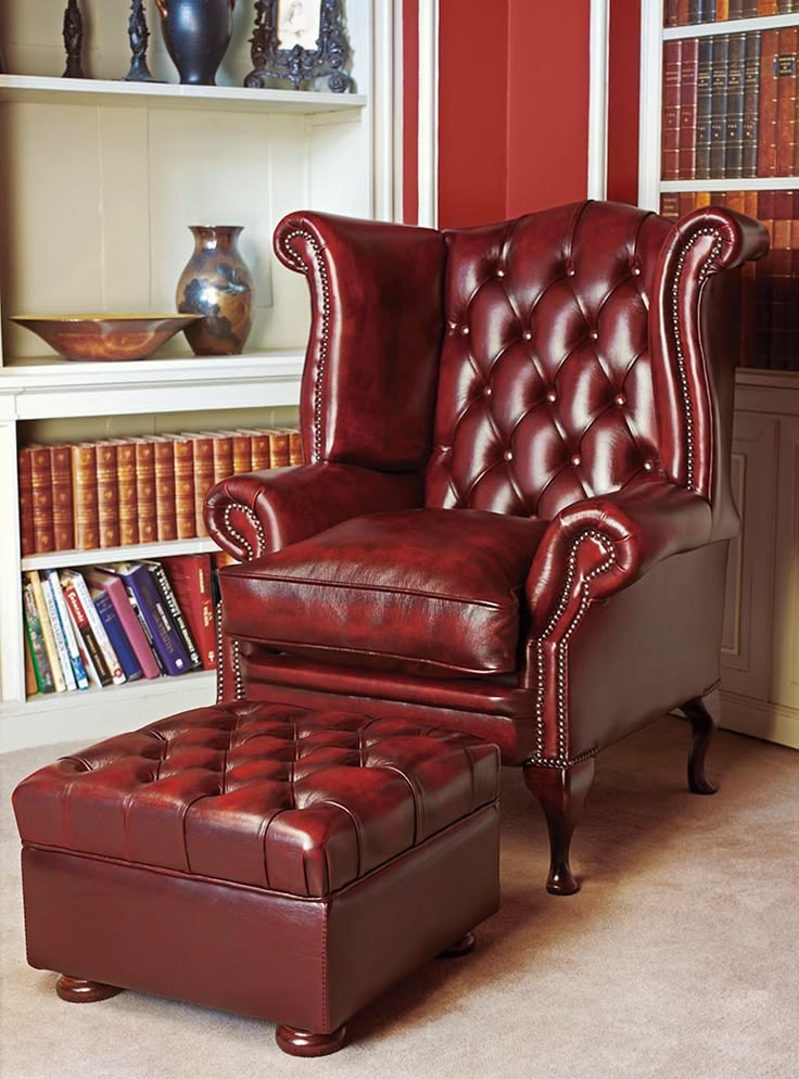 Oxblood red leather tufted wingback chair with matching ottoman